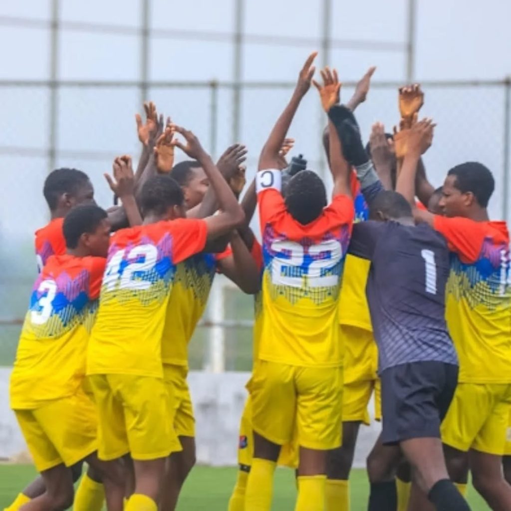 Imperial FC players celebrate passionately after scoring a goal in a Nationwide League One match, showcasing team spirit and youthful energy.