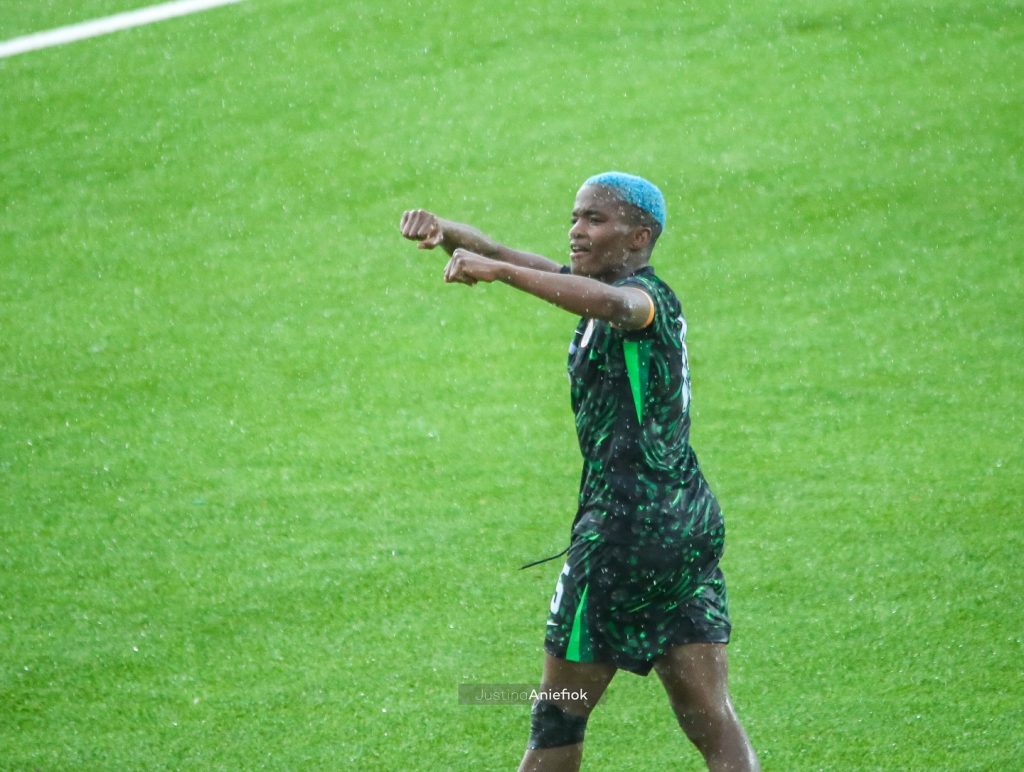 Rasheedat Ajibade’s Double Seals Super Falcons’ Commanding Victory Over Cameroon in Abeokuta Rasheedat Ajibade celebrates her goal against Cameroon with a triumphant fist pump at the MKO Abiola Stadium
