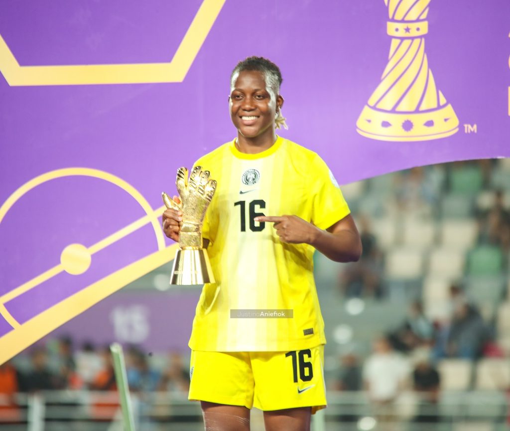 Chiamaka Nnadozie holds her Best Goalkeeper award at WAFCON 2024, smiling in her Super Falcons kit after Nigeria’s semi-final victory.