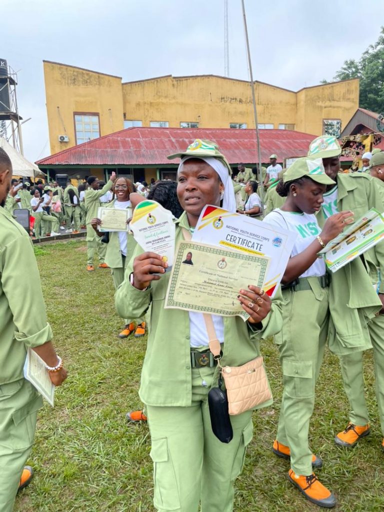 NYSC Passing Out Parade 2025: Corps Members Celebrate End of Service Across Nigeria Amina Aminu Mohammed, NYSC corps member in Ibadan North, holding her Certificate of National Service and an award plaque after the 2025 Passing Out Parade